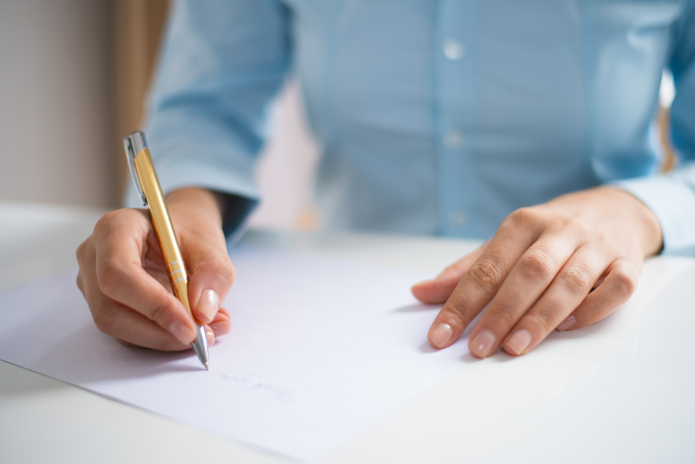 closeup woman writing sheet paper