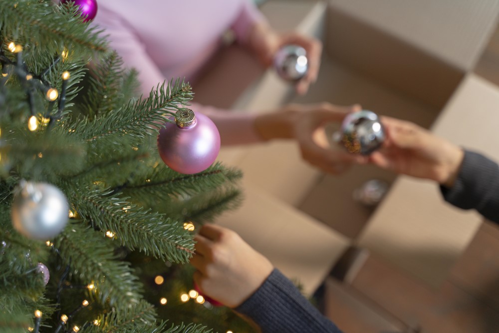 mother daughter decorating christmas tree